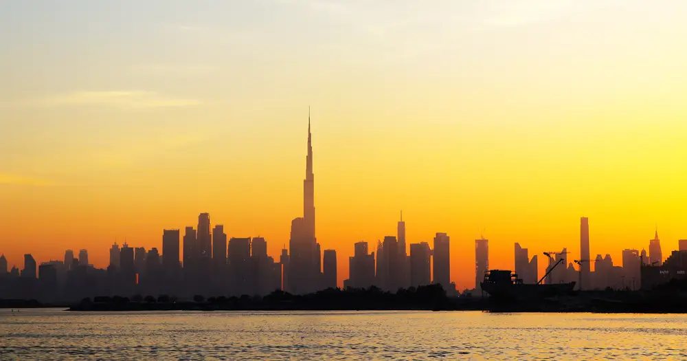 Golden sunset over Burj Khalifa and the Downtown Dubai skyline seen from Dubai Creek Harbour