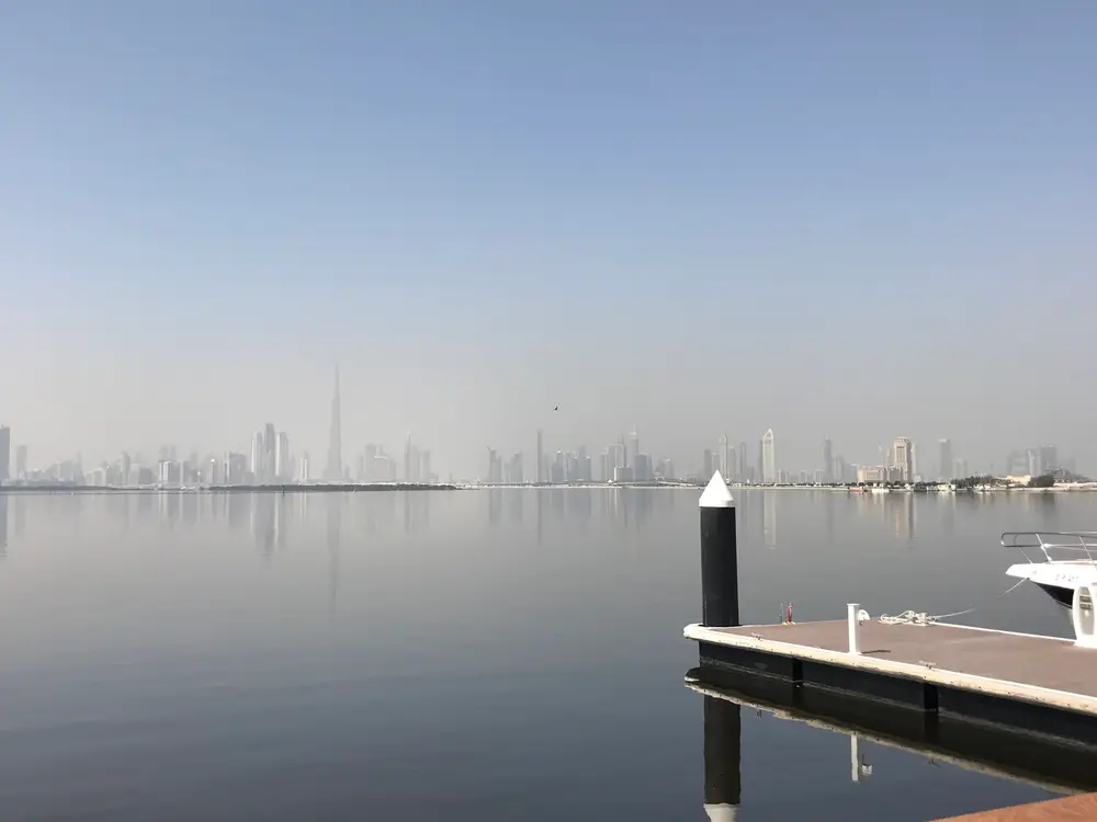 Calm creek waters facing the Dubai skyline seen from the Dubai Creek Harbour boardwalk