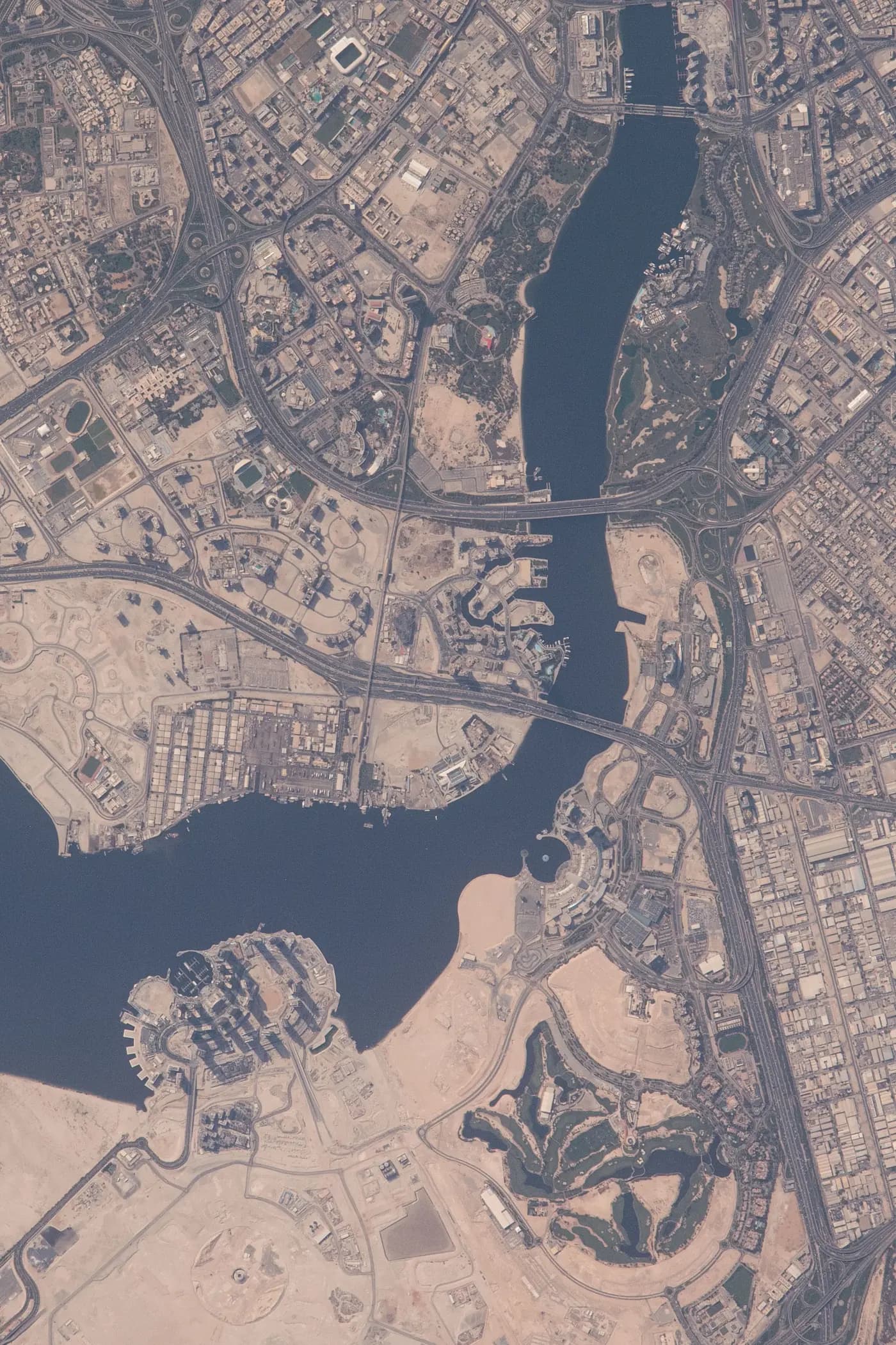 Satellite view of Dubai Creek showing the Dubai Creek Harbour island district beside the Ras Al Khor Wildlife Sanctuary